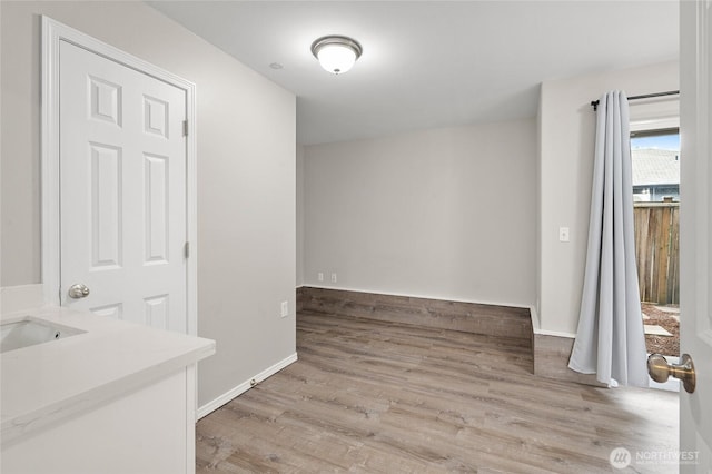 8077 165th Ln NE, Redmond, WA 98052 - unfurnished dining area featuring light wood-style floors and baseboards