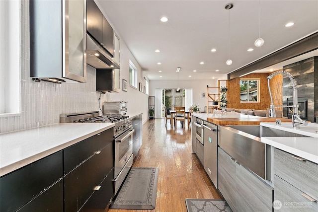 4113 Palatine Ave N, Seattle, WA 98103 - kitchen with appliances with stainless steel finishes, modern cabinets, recessed lighting, light wood finished floors, and decorative backsplash