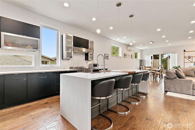 4113 Palatine Ave N, Seattle, WA 98103 - kitchen with light countertops, plenty of natural light, light wood-style flooring, recessed lighting, and a wall mounted air conditioner