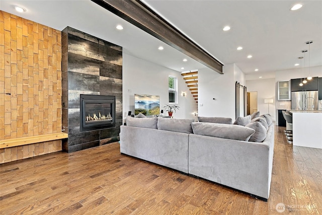 4113 Palatine Ave N, Seattle, WA 98103 - living area featuring wood finished floors, beamed ceiling, recessed lighting, a fireplace, and a barn door