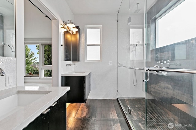 4113 Palatine Ave N, Seattle, WA 98103 - bathroom featuring a shower stall, two vanities, and wood finished floors