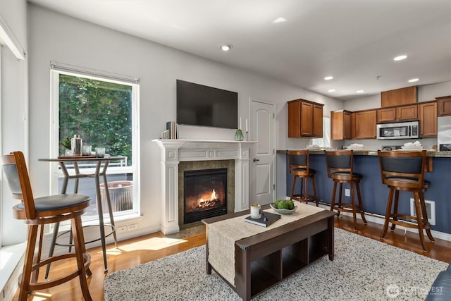 3112 SW Avalon Way Unit 102, Seattle, WA 98126 - living area featuring light wood-type flooring, recessed lighting, and a premium fireplace