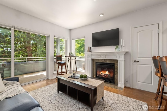 3112 SW Avalon Way Unit 102, Seattle, WA 98126 - living area with a tiled fireplace, wood finished floors, and recessed lighting
