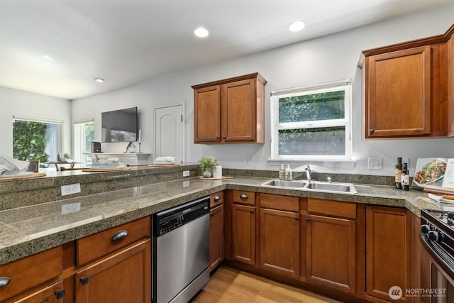 3112 SW Avalon Way Unit 102, Seattle, WA 98126 - kitchen featuring stainless steel dishwasher, tile counters, brown cabinetry, range, and light wood-style flooring