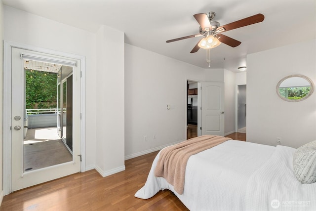 3112 SW Avalon Way Unit 102, Seattle, WA 98126 - bedroom with black fridge, wood finished floors, access to outside, and ceiling fan