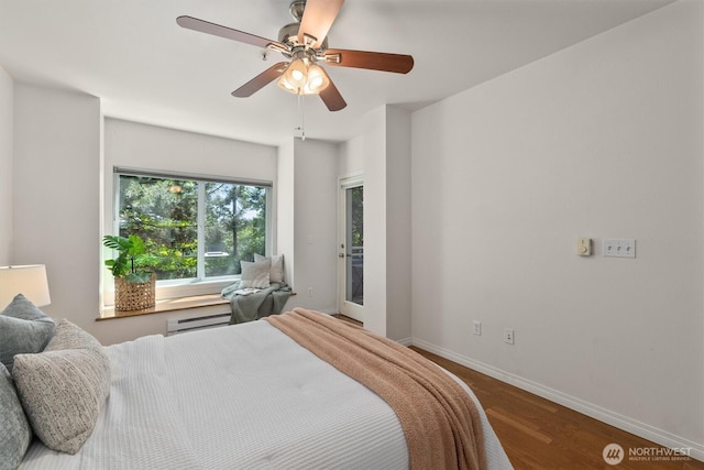 3112 SW Avalon Way Unit 102, Seattle, WA 98126 - bedroom featuring a baseboard heating unit, wood finished floors, and a ceiling fan