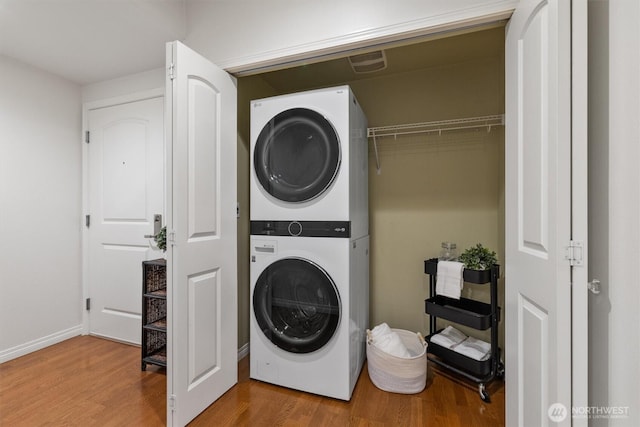 3112 SW Avalon Way Unit 102, Seattle, WA 98126 - laundry area with stacked washer / dryer and wood finished floors