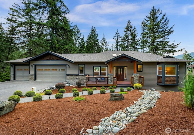 8 Southern Ct, Bellingham, WA 98229 - view of front of property featuring a garage, driveway, stone siding, and covered porch