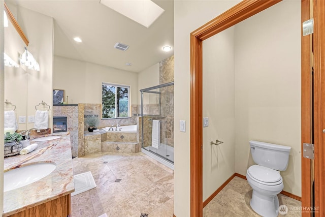 8 Southern Ct, Bellingham, WA 98229 - bathroom with a glass covered fireplace, a bath, double vanity, a shower stall, and a skylight