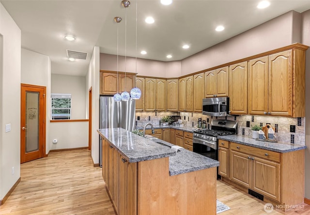 8 Southern Ct, Bellingham, WA 98229 - kitchen with appliances with stainless steel finishes, decorative backsplash, light wood-style floors, dark stone countertops, and recessed lighting