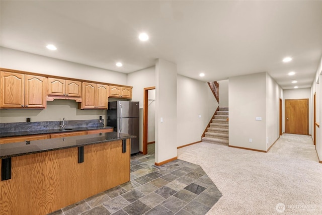 8 Southern Ct, Bellingham, WA 98229 - kitchen featuring freestanding refrigerator, a kitchen bar, recessed lighting, dark colored carpet, and dark stone counters