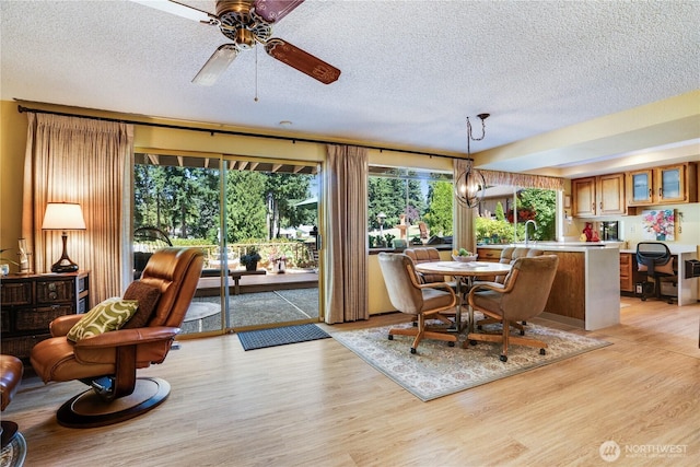 3500 SW 325th St, Federal Way, WA 98023 - dining space with a textured ceiling, light wood-type flooring, and ceiling fan