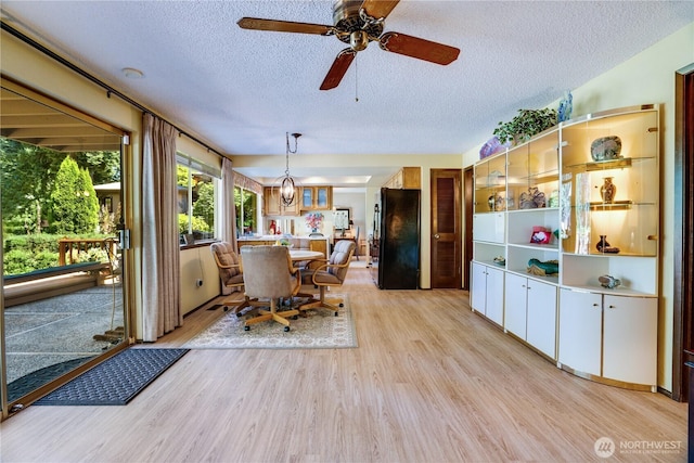 3500 SW 325th St, Federal Way, WA 98023 - dining room featuring a textured ceiling, light wood-type flooring, and a ceiling fan