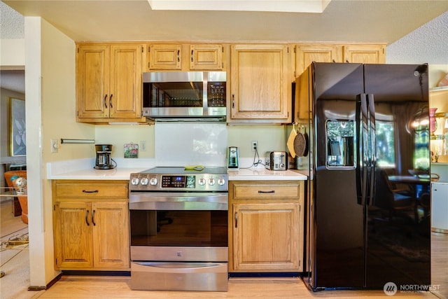 3500 SW 325th St, Federal Way, WA 98023 - kitchen with appliances with stainless steel finishes, light countertops, and light wood-type flooring