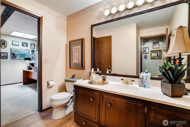 3500 SW 325th St, Federal Way, WA 98023 - bathroom featuring wood finished floors, vanity, and wallpapered walls