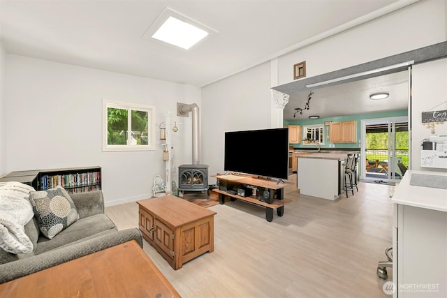 6070 Saxon Rd, Acme, WA 98220 - living area featuring a wood stove and light wood-style floors
