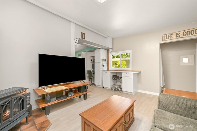 6070 Saxon Rd, Acme, WA 98220 - living area featuring light wood-type flooring, a wood stove, and built in study area