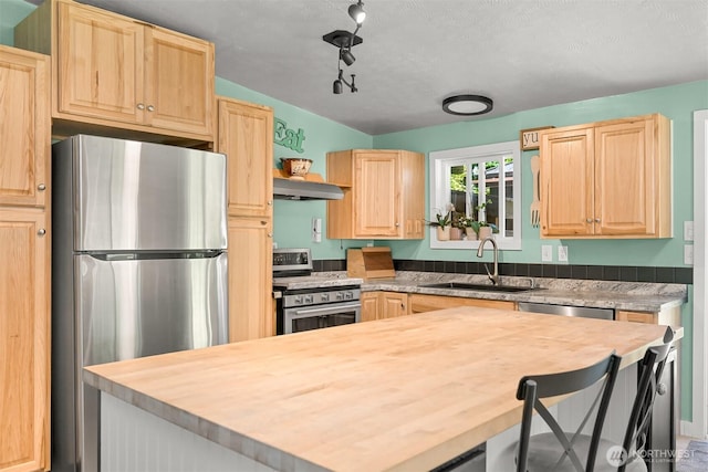 6070 Saxon Rd, Acme, WA 98220 - kitchen with stainless steel appliances, butcher block countertops, light brown cabinets, under cabinet range hood, and a center island