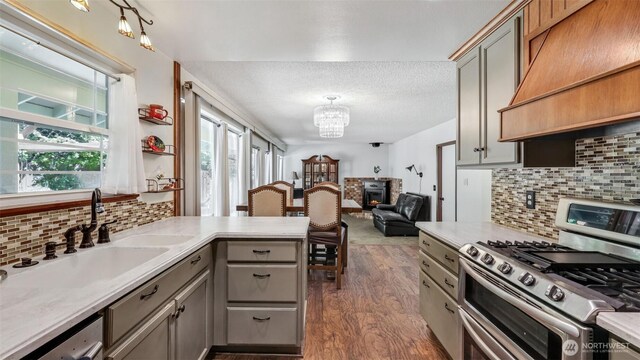 16621 148th Ave SE, Renton, WA 98058 - kitchen featuring stainless steel appliances, gray cabinets, premium range hood, dark wood finished floors, and a chandelier