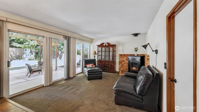 16621 148th Ave SE, Renton, WA 98058 - carpeted living room featuring a textured ceiling and plenty of natural light