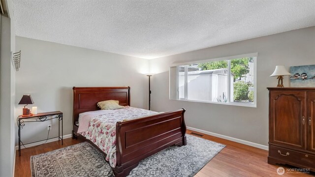 16621 148th Ave SE, Renton, WA 98058 - bedroom featuring a textured ceiling and light wood-type flooring