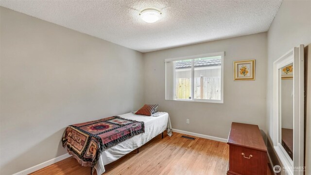16621 148th Ave SE, Renton, WA 98058 - bedroom with light wood-type flooring and a textured ceiling