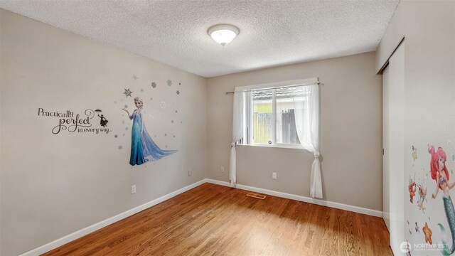 16621 148th Ave SE, Renton, WA 98058 - unfurnished room featuring a textured ceiling and light wood-style floors