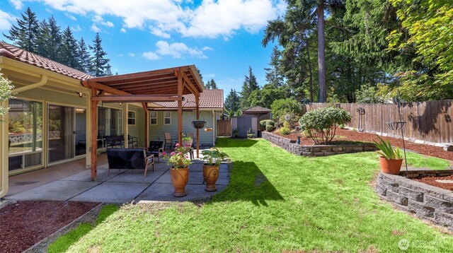 16621 148th Ave SE, Renton, WA 98058 - fenced backyard featuring a storage unit and a patio area
