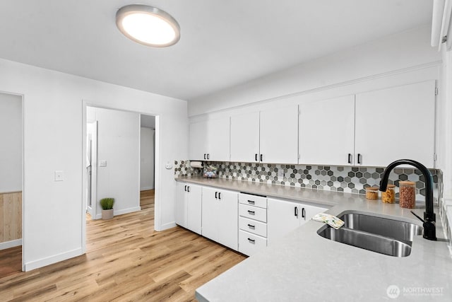 1528 NE 166th St, Shoreline, WA 98155 - kitchen featuring light countertops, tasteful backsplash, white cabinetry, and light wood-style floors
