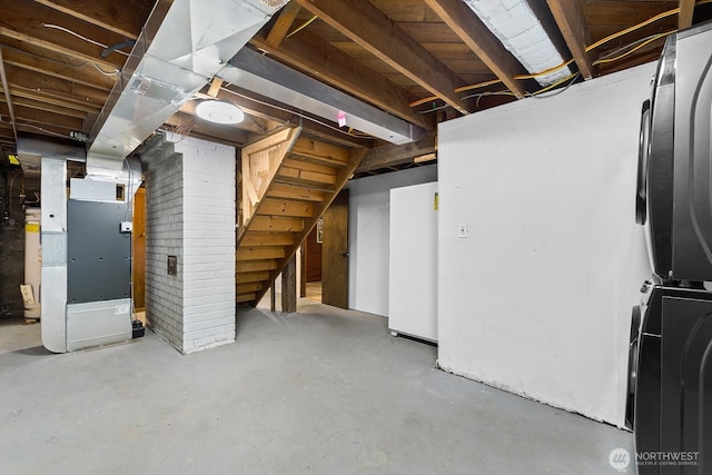 1528 NE 166th St, Shoreline, WA 98155 - unfinished basement with heating unit, stairs, stacked washer and clothes dryer, and fridge