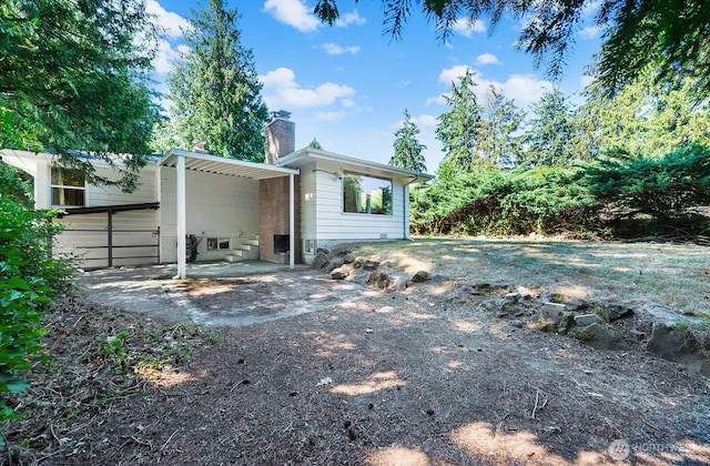 1528 NE 166th St, Shoreline, WA 98155 - rear view of property with driveway, a chimney, and a carport