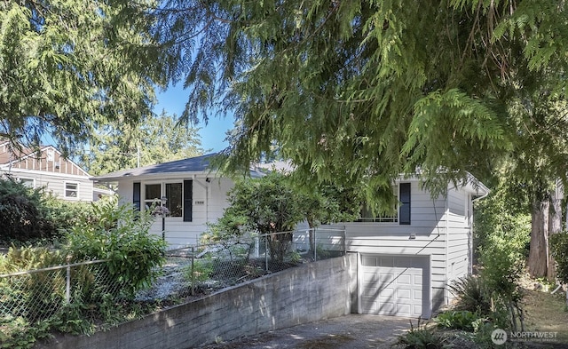1528 NE 166th St, Shoreline, WA 98155 - obstructed view of property featuring an attached garage and concrete driveway