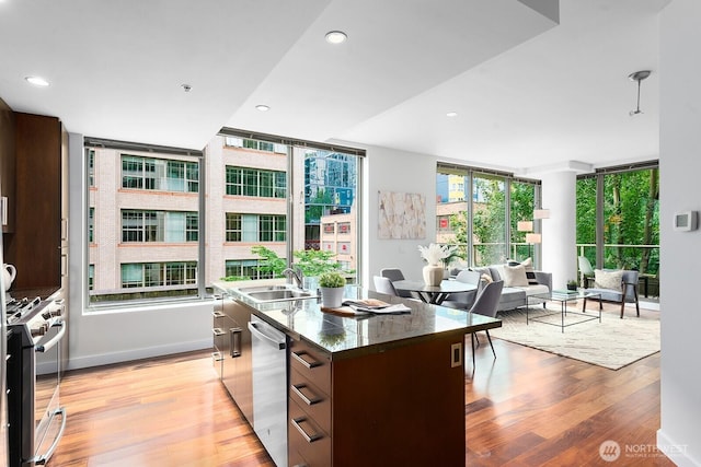 910 Lenora St Unit S403, Seattle, WA 98121 - kitchen with appliances with stainless steel finishes, a center island with sink, open floor plan, light wood-style floors, and modern cabinets