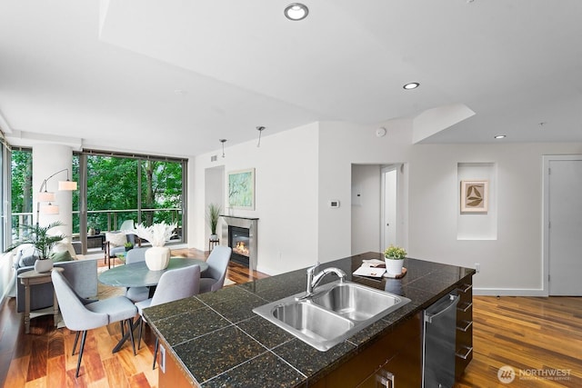 910 Lenora St Unit S403, Seattle, WA 98121 - kitchen with a fireplace, dishwasher, a center island with sink, wood finished floors, and tile counters