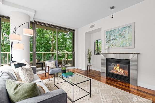 910 Lenora St Unit S403, Seattle, WA 98121 - living area with expansive windows, wood finished floors, and a glass covered fireplace