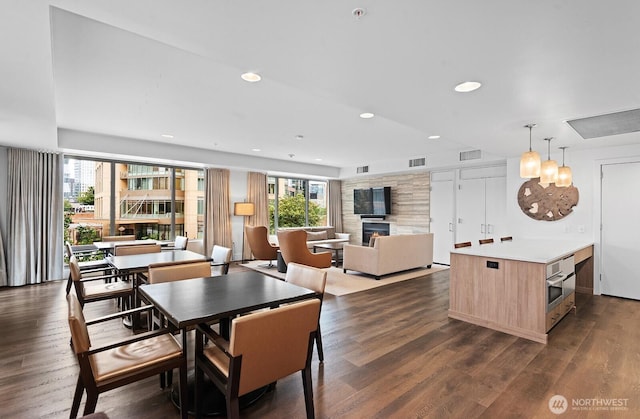 910 Lenora St Unit S403, Seattle, WA 98121 - dining area with a fireplace, plenty of natural light, dark wood finished floors, and recessed lighting