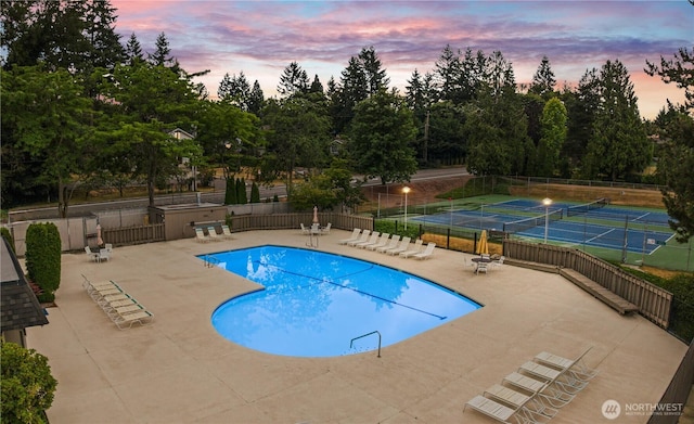 2514 174th Ave NE, Redmond, WA 98052 - pool at dusk with a patio, a community pool, a tennis court, and view of wooded area