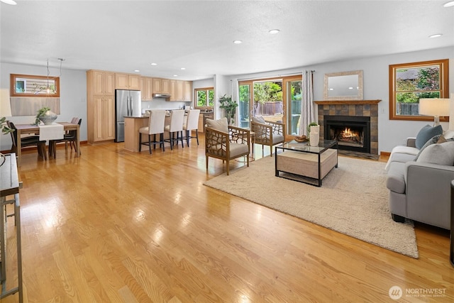 23303 13th Pl W, Bothell, WA 98021 - living room featuring a fireplace, light wood-style flooring, and recessed lighting