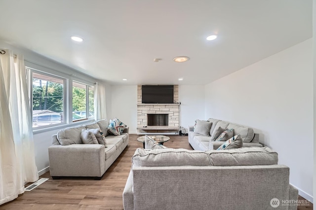 721 S 304th St, Federal Way, WA 98003 - living room with light wood-style flooring, a stone fireplace, and recessed lighting