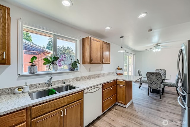 721 S 304th St, Federal Way, WA 98003 - kitchen with dishwasher, freestanding refrigerator, a peninsula, brown cabinetry, and recessed lighting