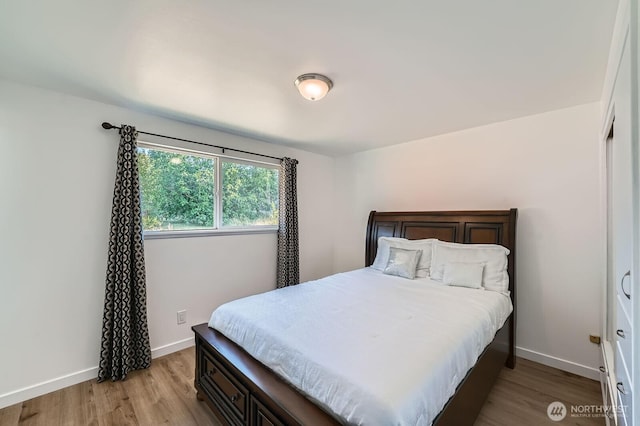 721 S 304th St, Federal Way, WA 98003 - bedroom with light wood-type flooring and baseboards