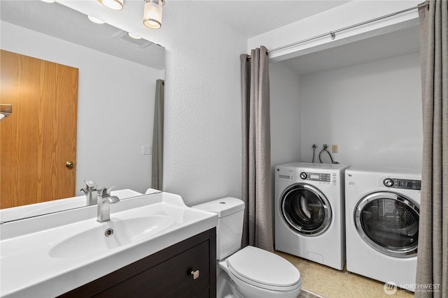 24814 SE 145th Ln, Kent, WA 98042 - bathroom featuring washer and dryer and vanity