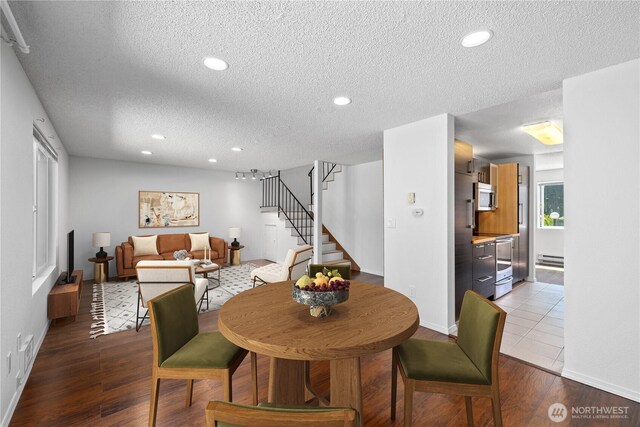 24814 SE 145th Ln, Kent, WA 98042 - dining area featuring a textured ceiling, stairway, recessed lighting, baseboard heating, and wood finished floors