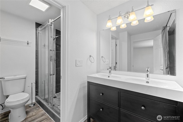 24814 SE 145th Ln, Kent, WA 98042 - full bathroom featuring wood finished floors, double vanity, and a stall shower