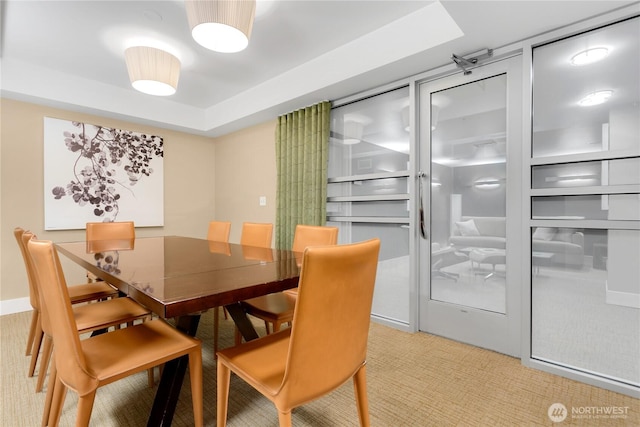 2911 2nd Ave Unit 1117, Seattle, WA 98121 - dining space with light colored carpet and a tray ceiling