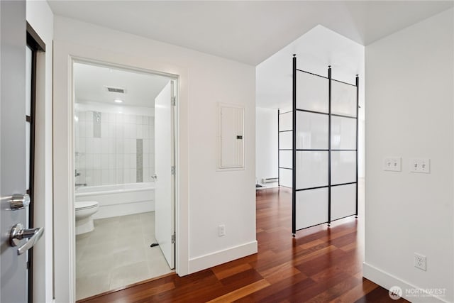 2911 2nd Ave Unit 1117, Seattle, WA 98121 - corridor featuring wood finished floors and electric panel