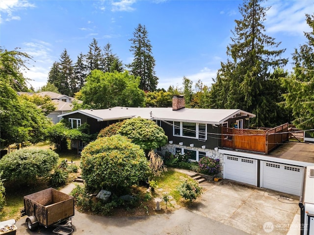 22616 88th Ave W, Edmonds, WA 98026 - view of front of home with a chimney, concrete driveway, and a garage