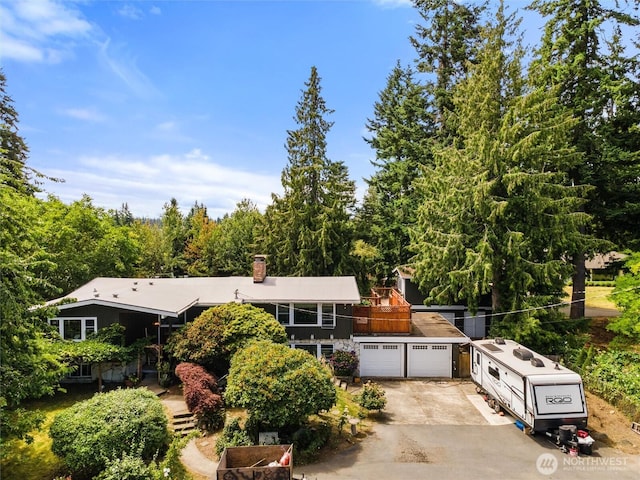 22616 88th Ave W, Edmonds, WA 98026 - view of front of house with concrete driveway, a chimney, and a garage