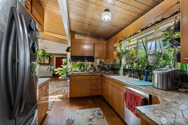 22616 88th Ave W, Edmonds, WA 98026 - kitchen with freestanding refrigerator, dishwasher, dark wood-style flooring, brown cabinets, and lofted ceiling