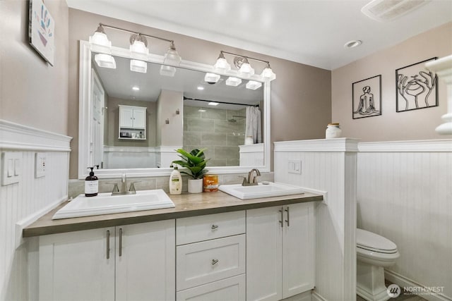 22616 88th Ave W, Edmonds, WA 98026 - full bathroom featuring double vanity, a tile shower, and a wainscoted wall
